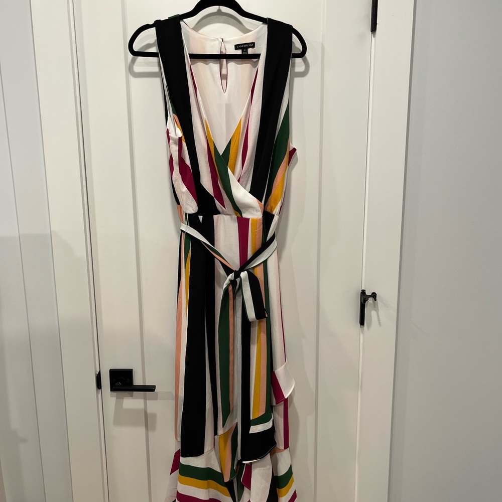 Striped faux wrap dress with tie waist and ruffle detail.
